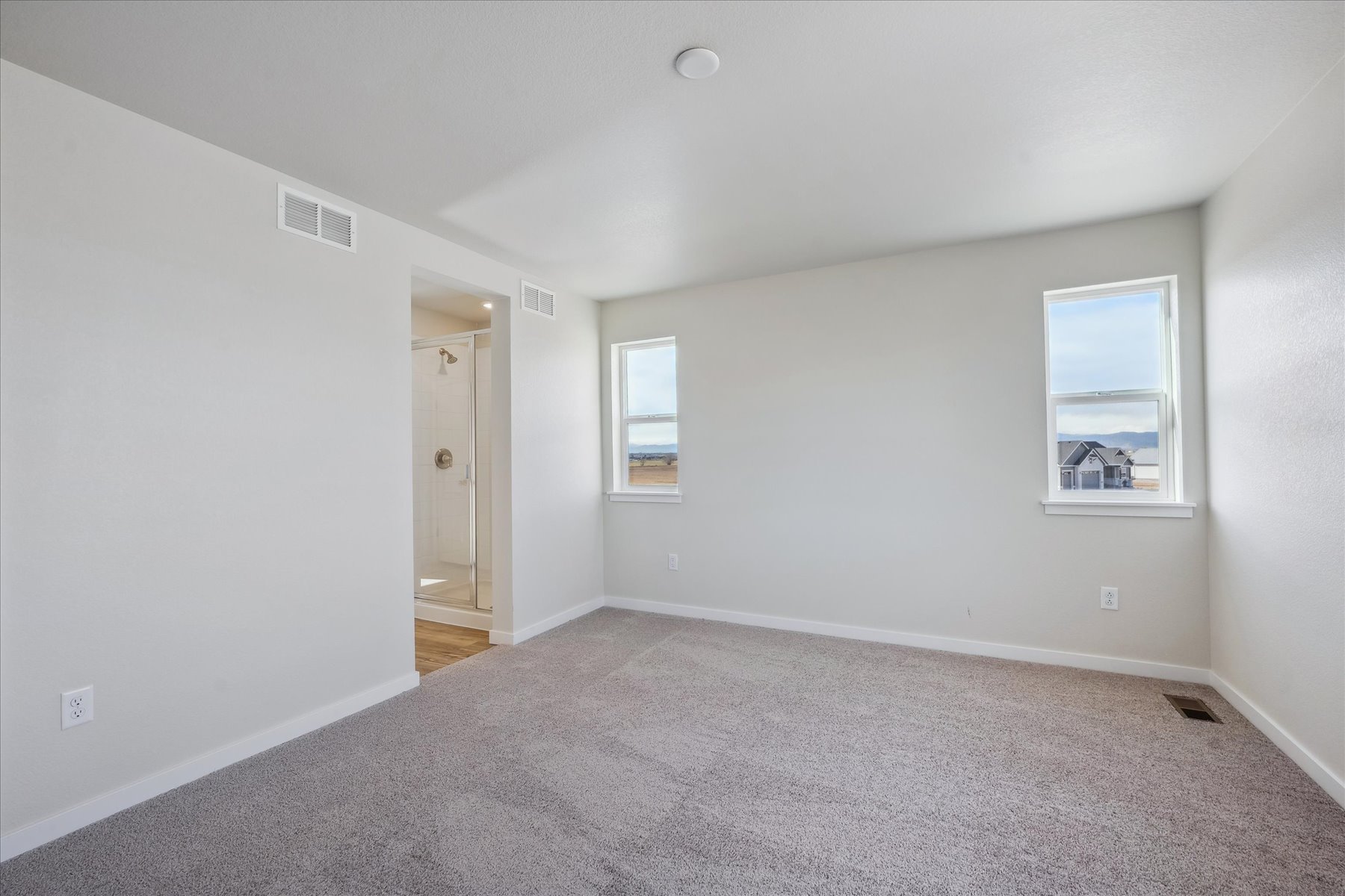 A room with a carpet and a door.
