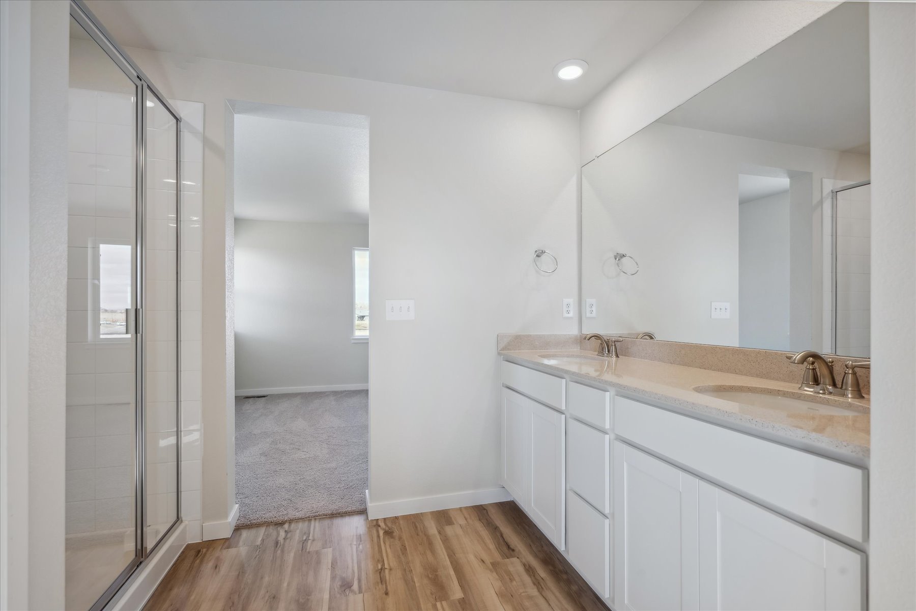 A bathroom with a shower and sink.