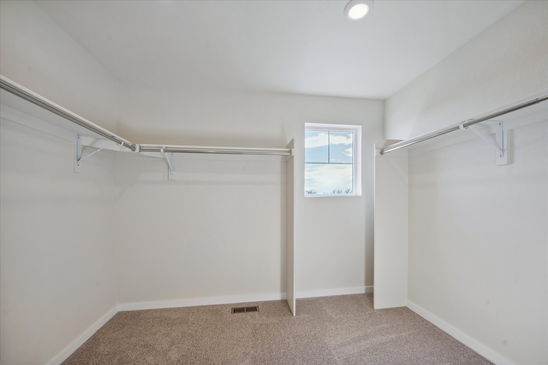 A room with a window and a carpet.
