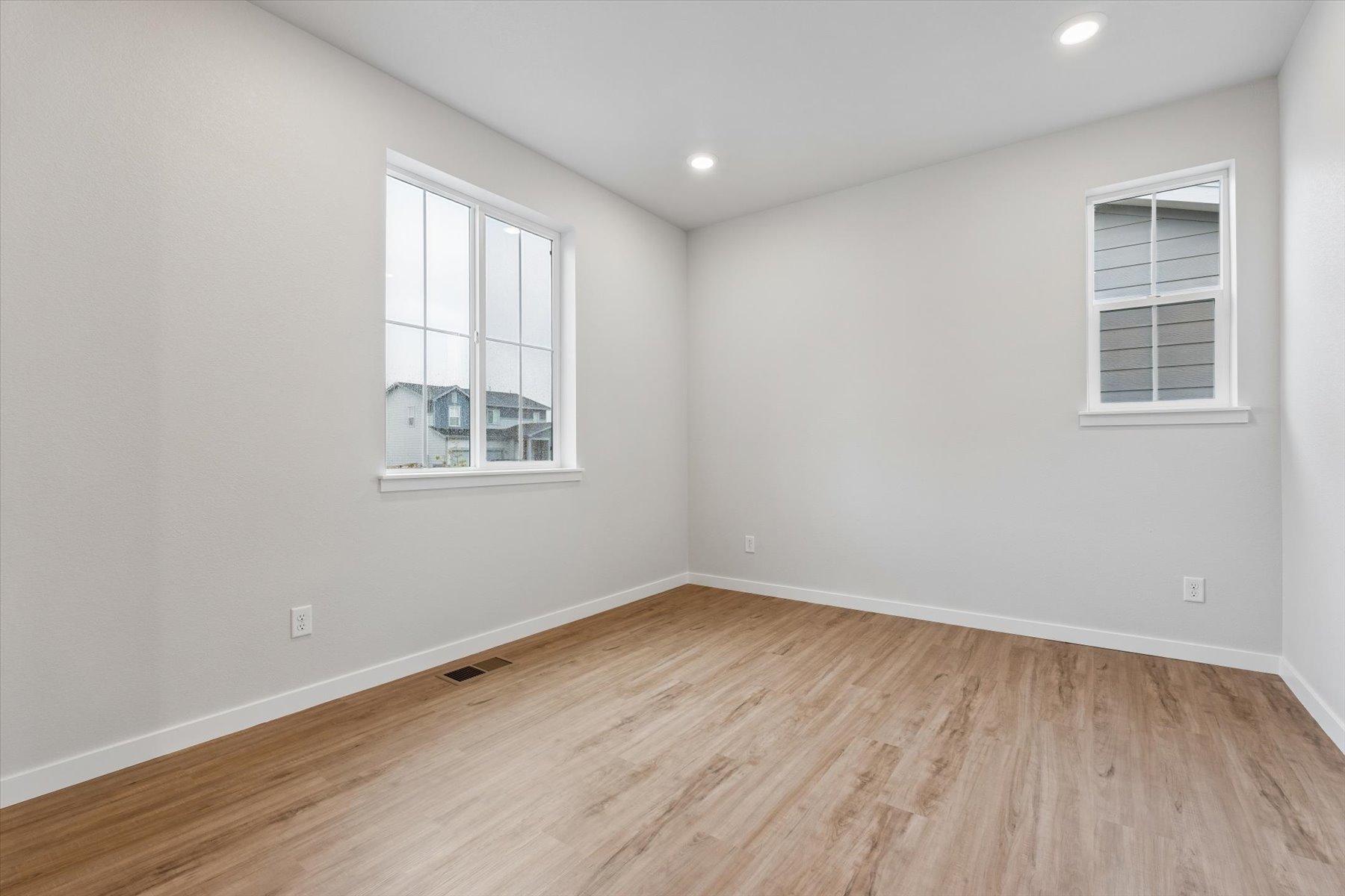 A room with a wood floor and a window.