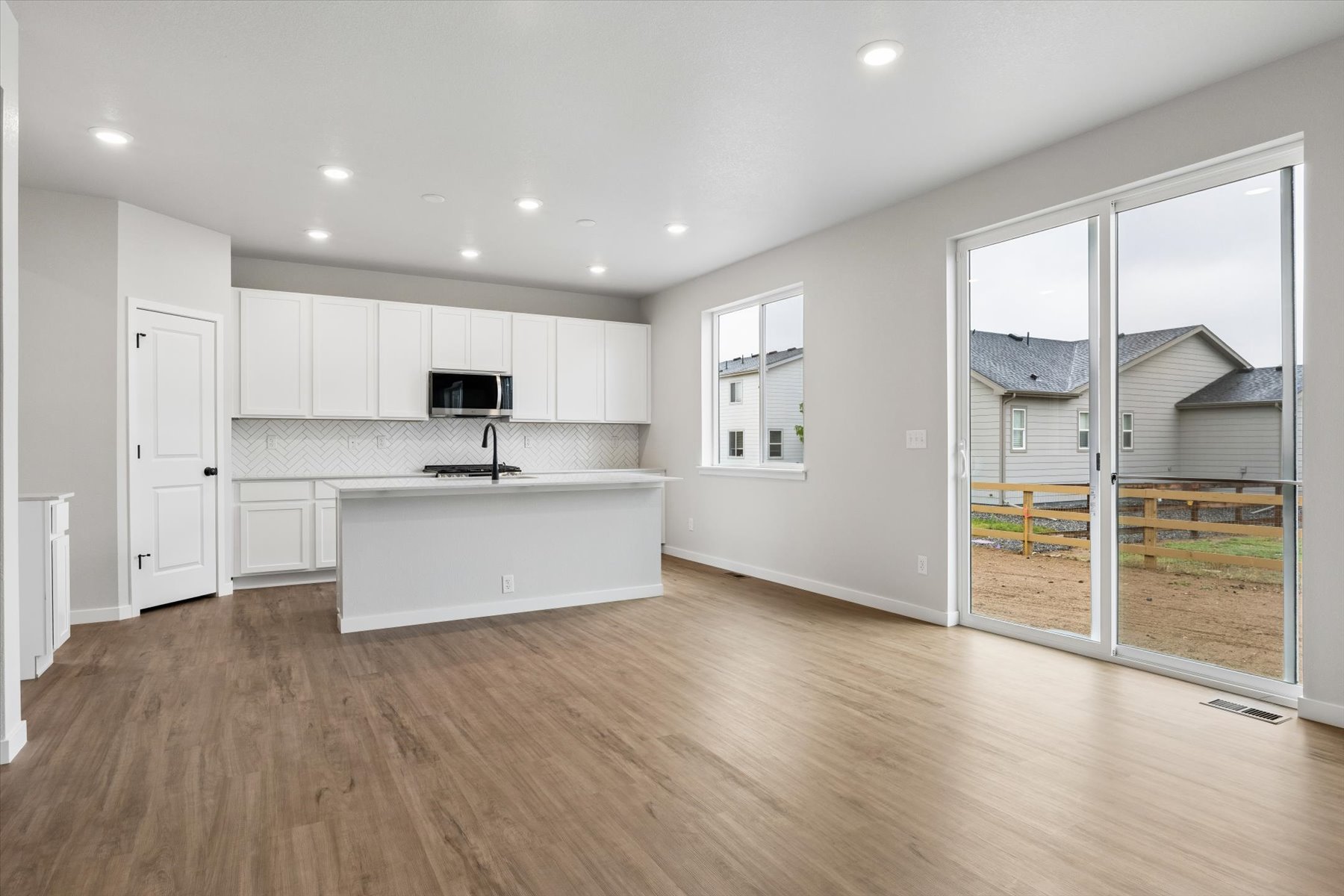 A kitchen with white cabinets.