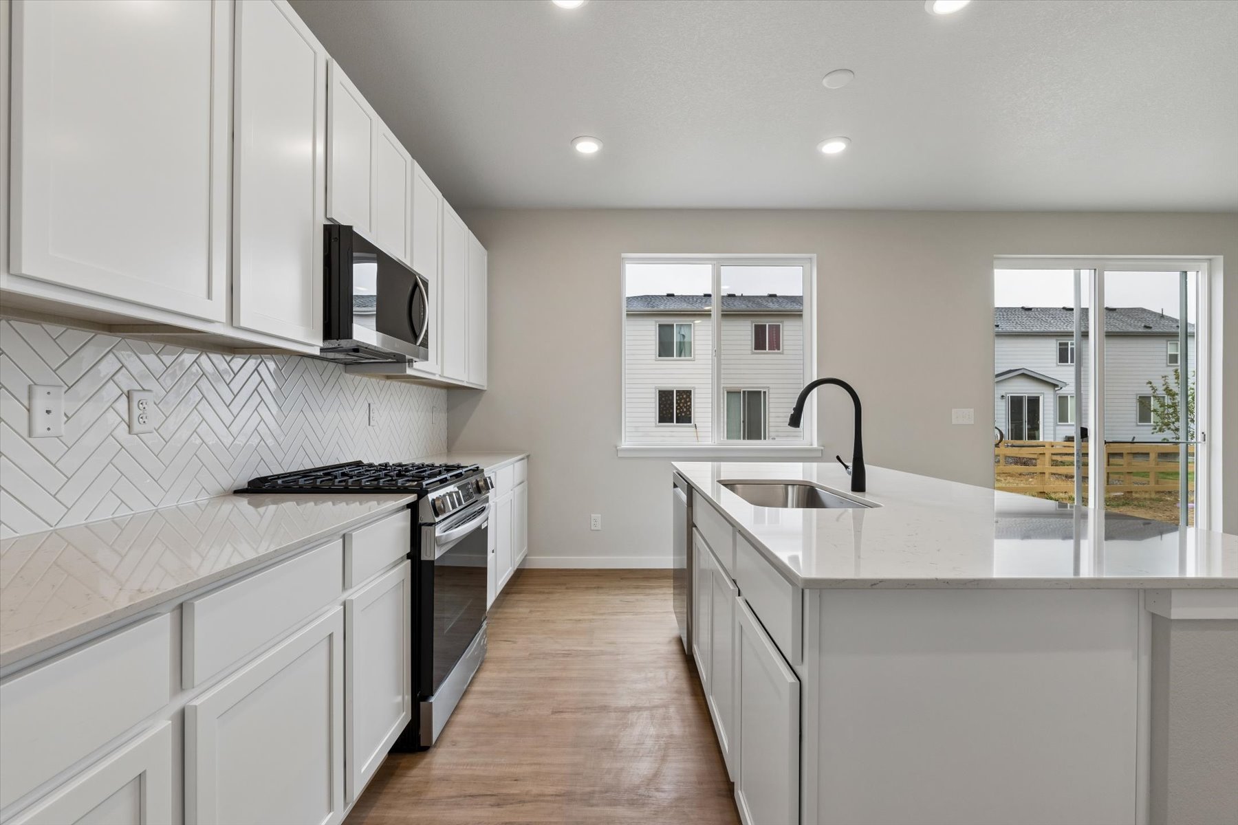 A kitchen with white cabinets.