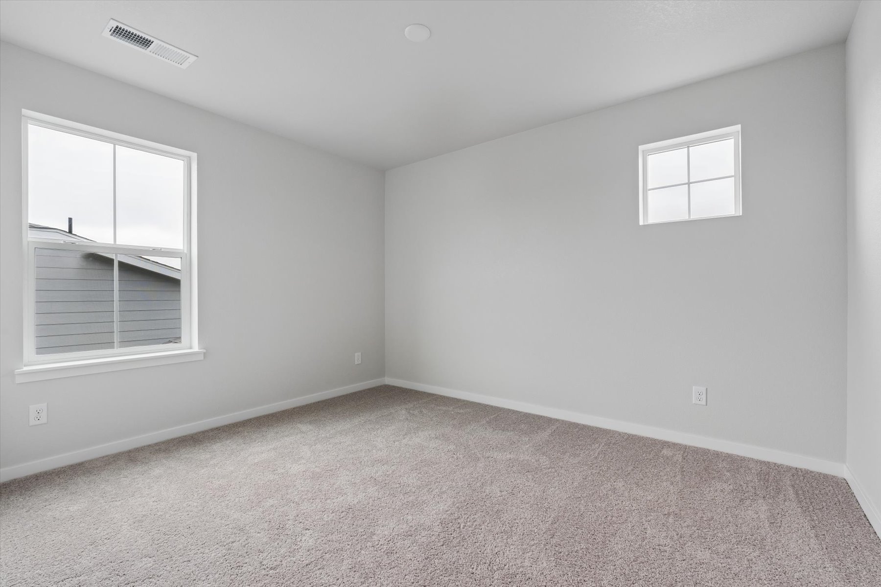 A room with a window and a carpet.
