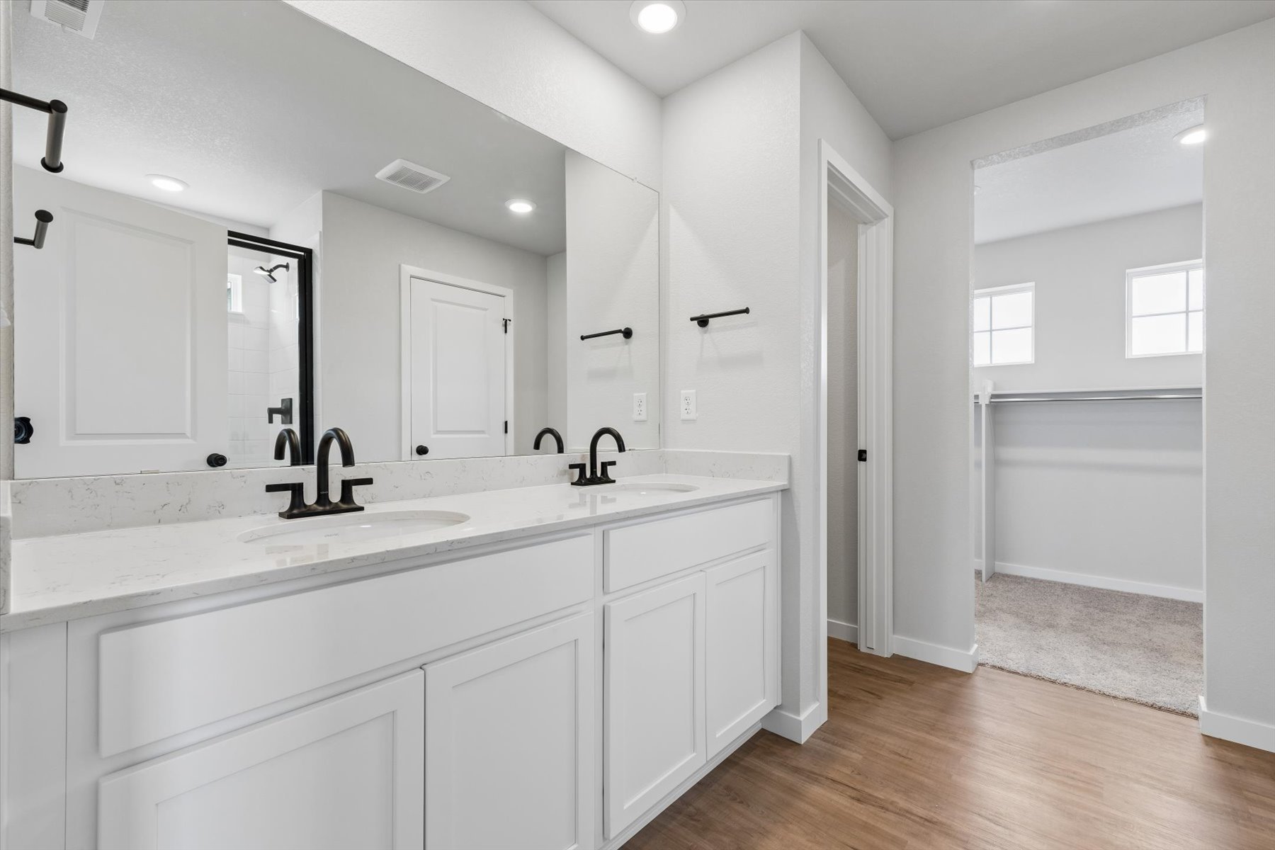 A bathroom with white cabinets.