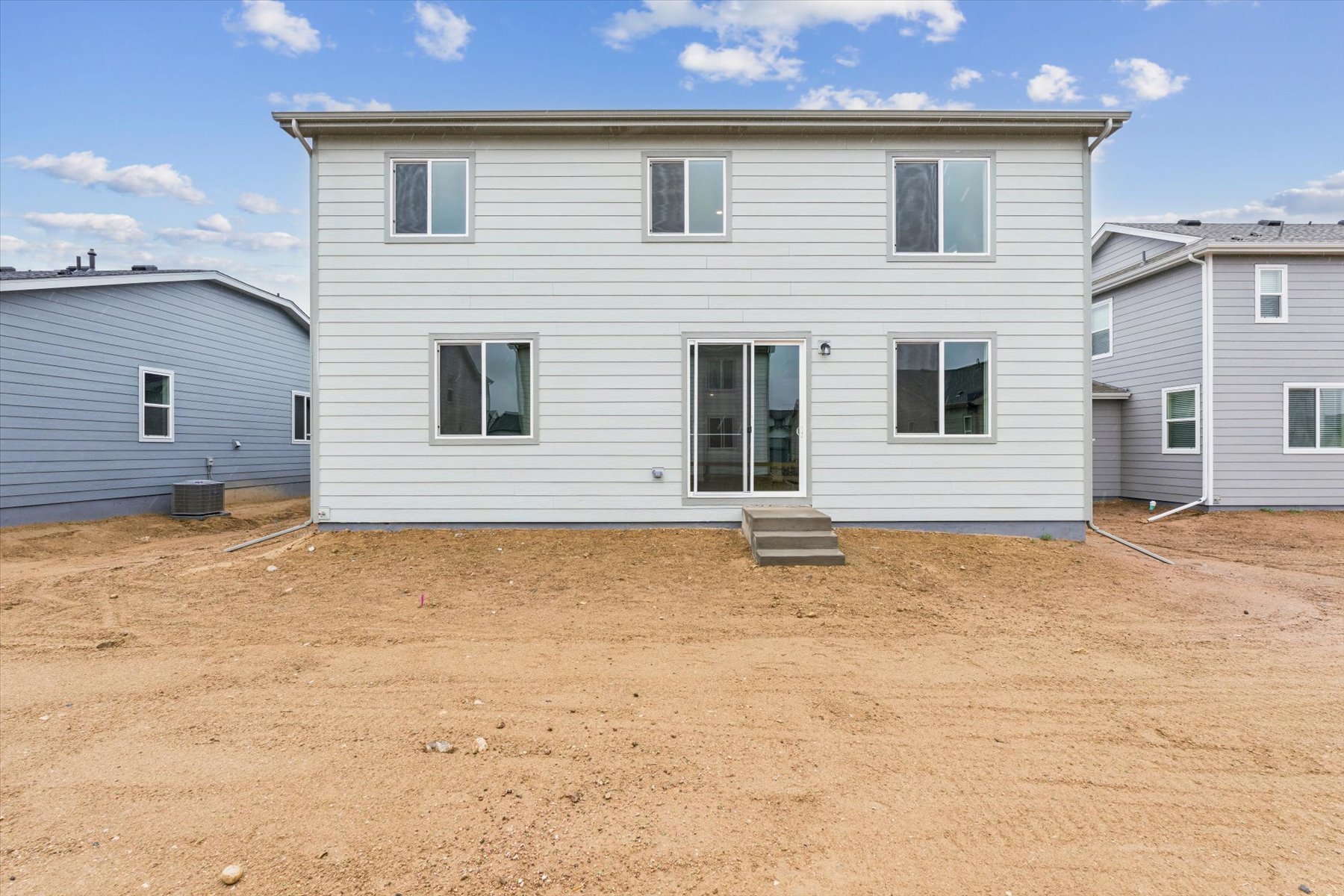 A house with a dirt yard.