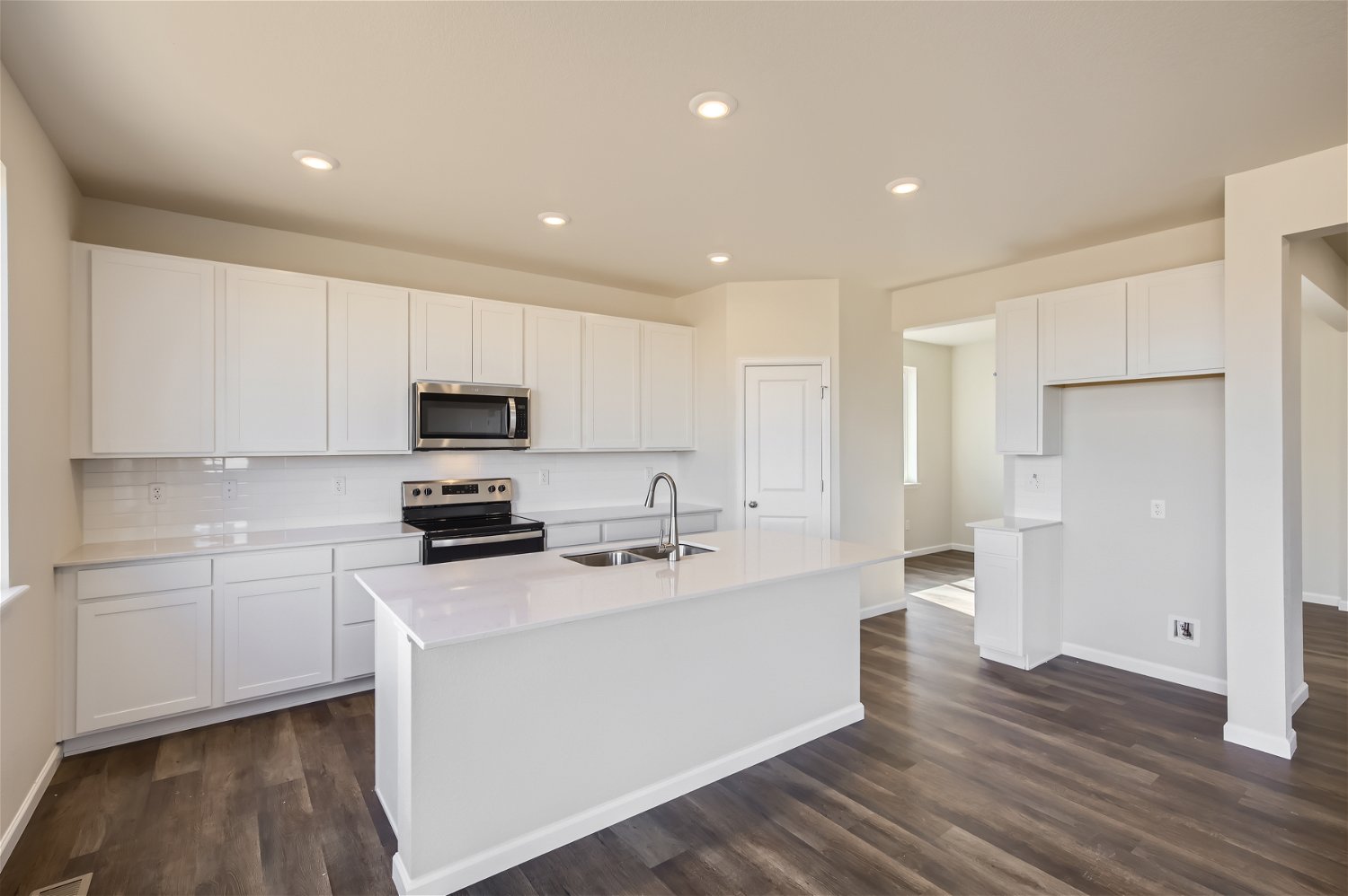 A kitchen with white cabinets.