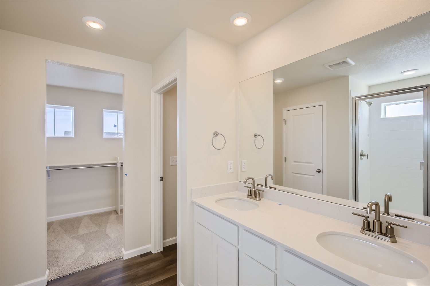 A bathroom with a large mirror.