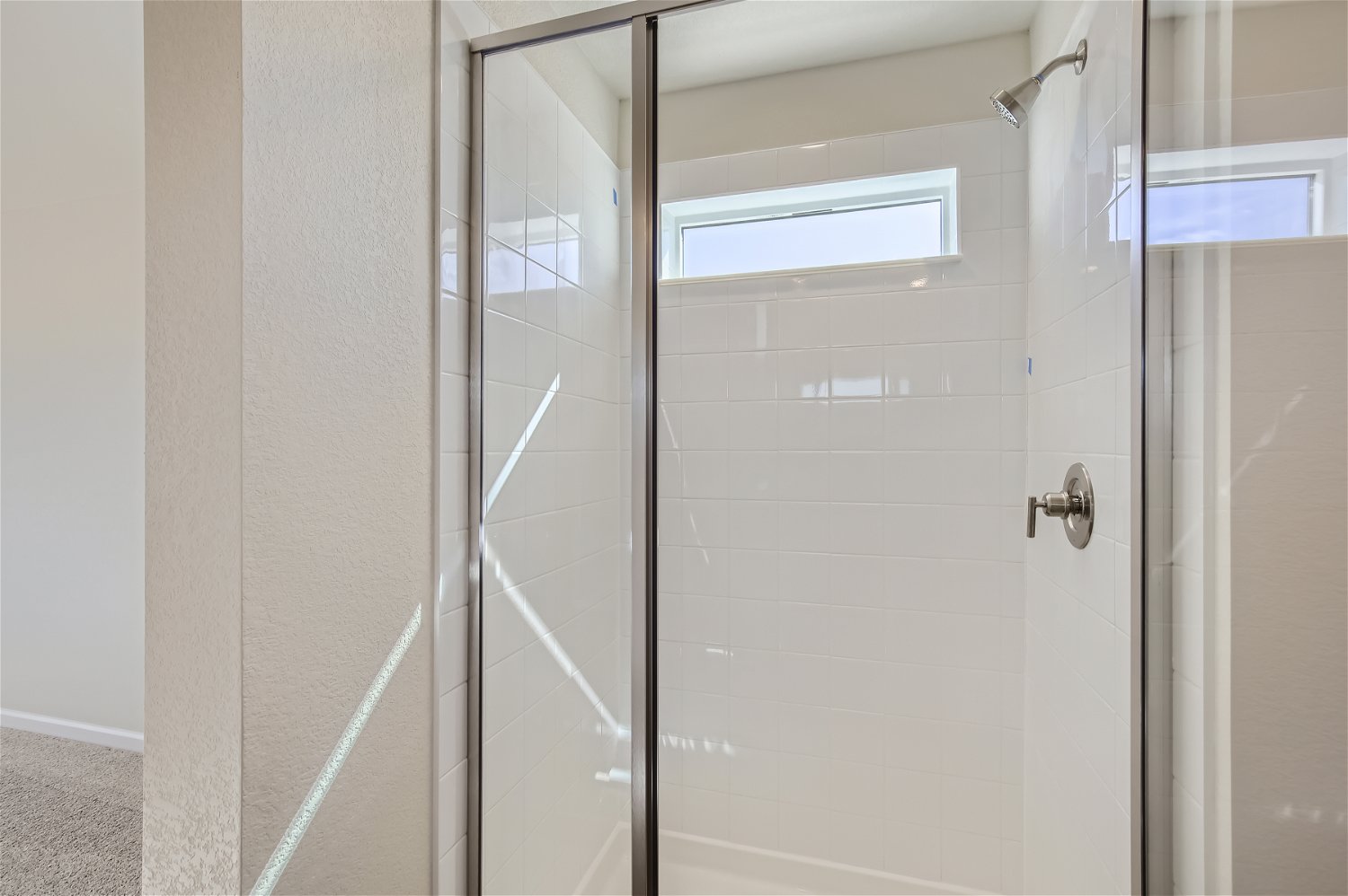 A shower with a glass door.