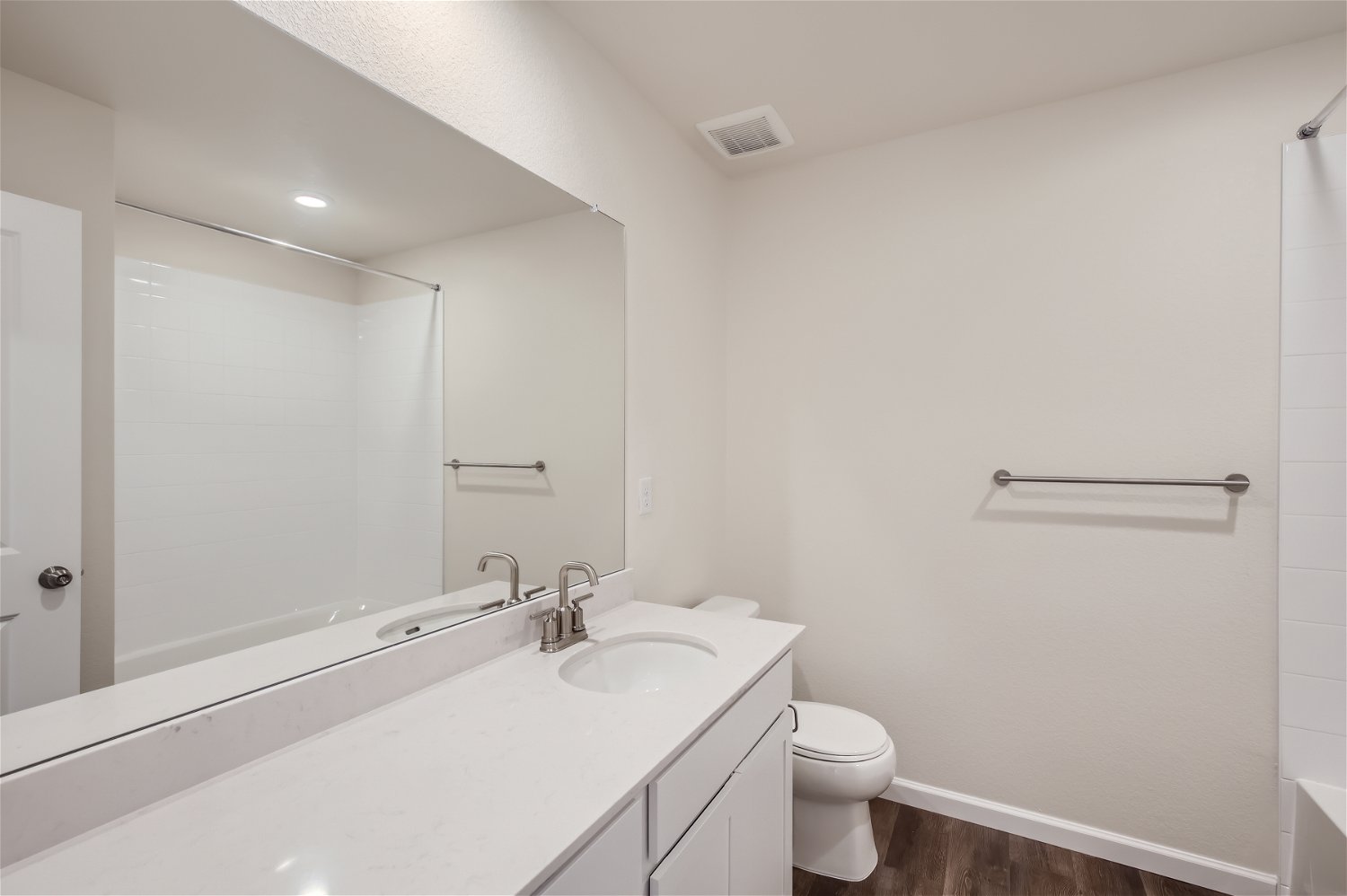 A bathroom with a tub sink and toilet.