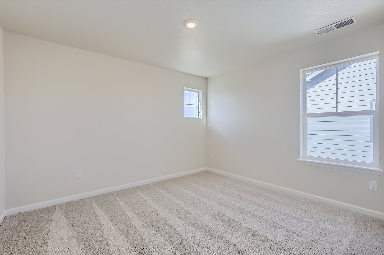 A room with a tile floor and windows.