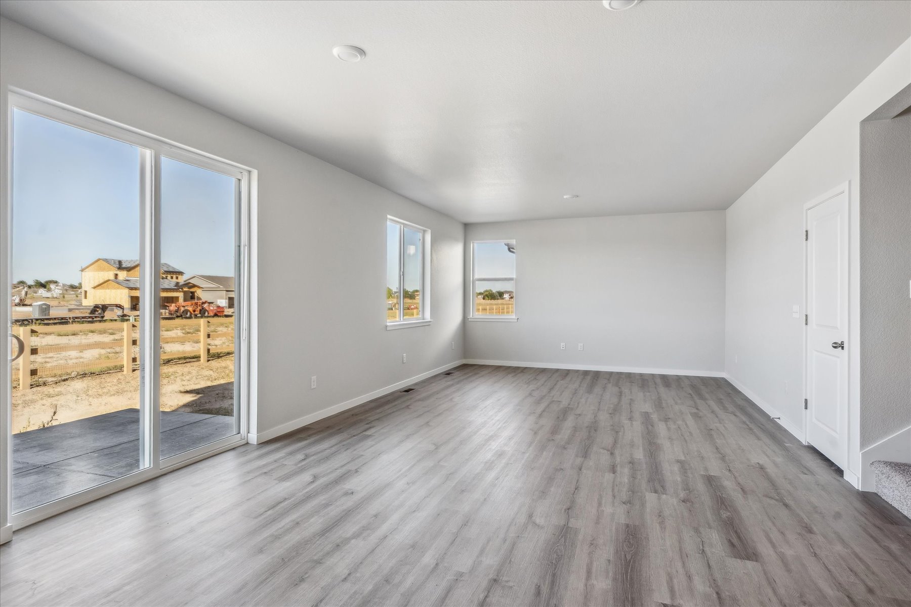 A room with a wood floor and glass doors.