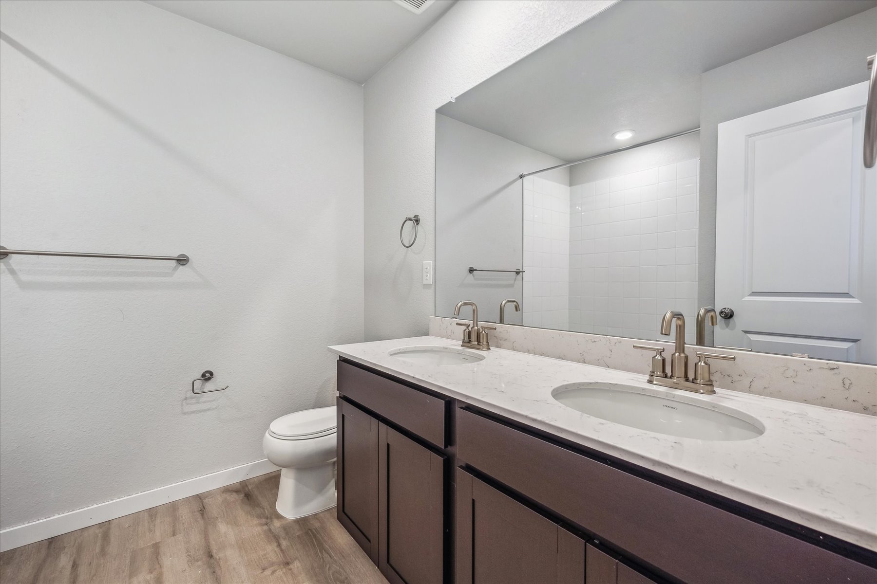 A bathroom with a large mirror.