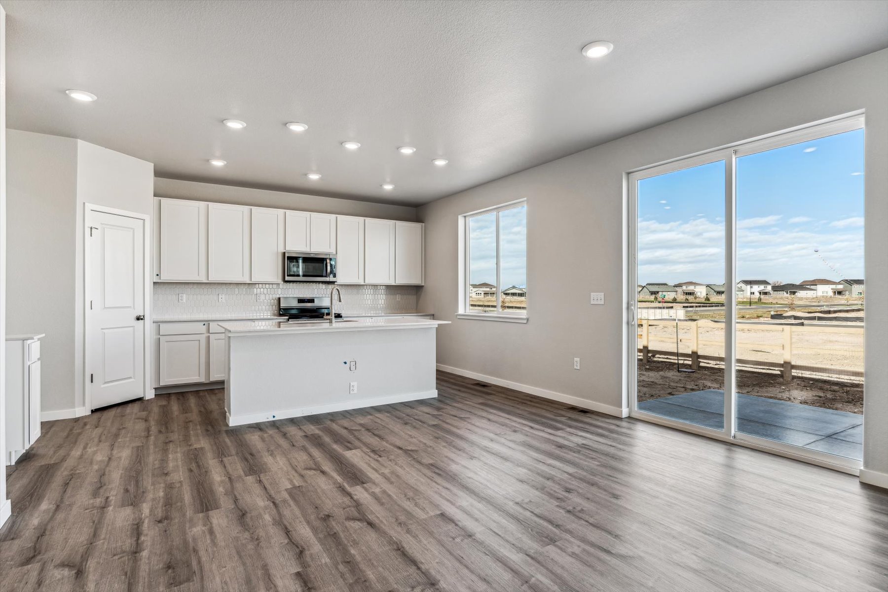 A kitchen with a large glass door.