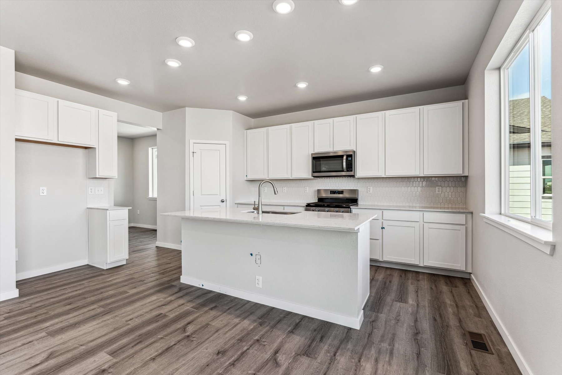 A kitchen with white cabinets.