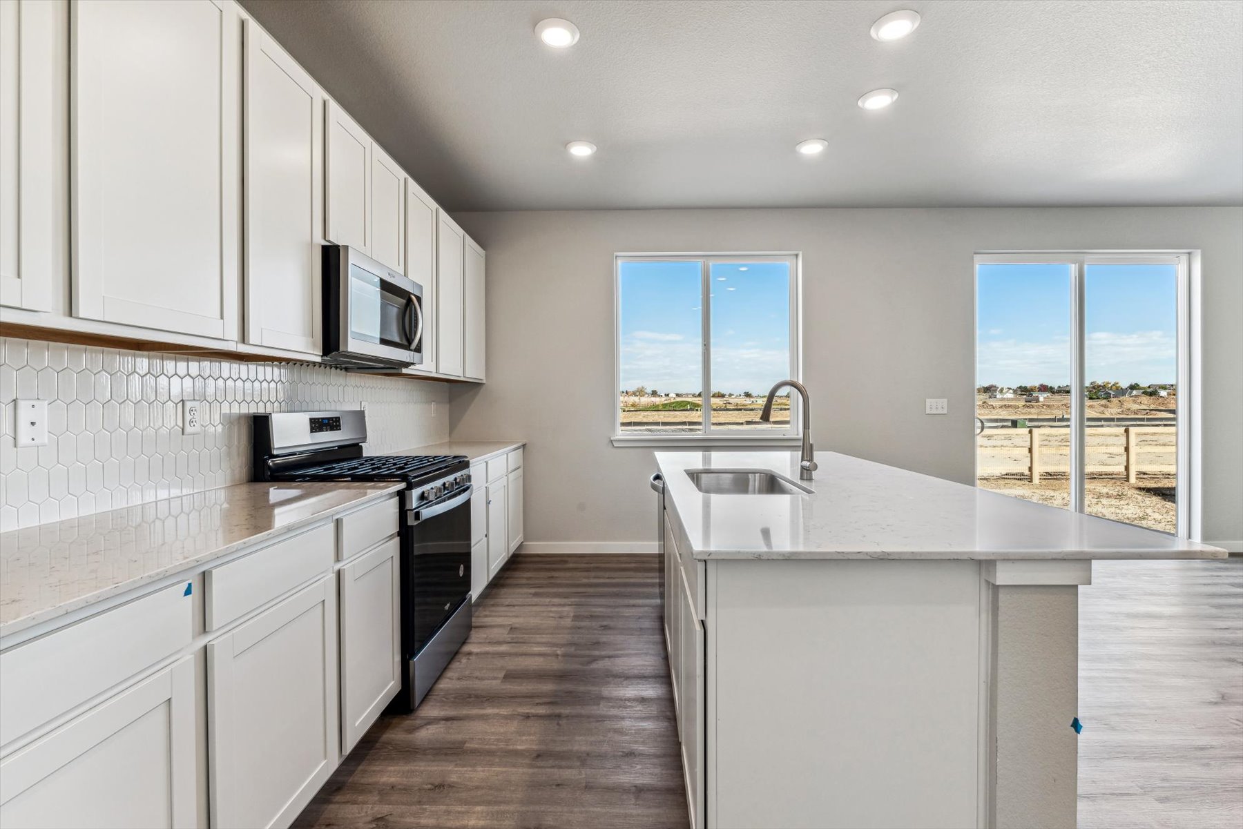 A kitchen with white cabinets.