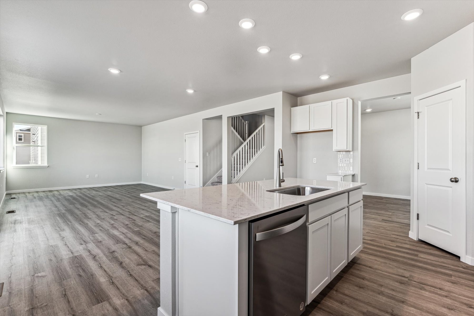 A kitchen with white cabinets.