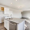 Kitchen island and great room of the Fraser floor plan by Century Communities