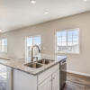 Kitchen in natural light of windows of the Fraser floor plan by Century Communities