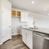 Kitchen island and great room of the Fraser floor plan by Century Communities