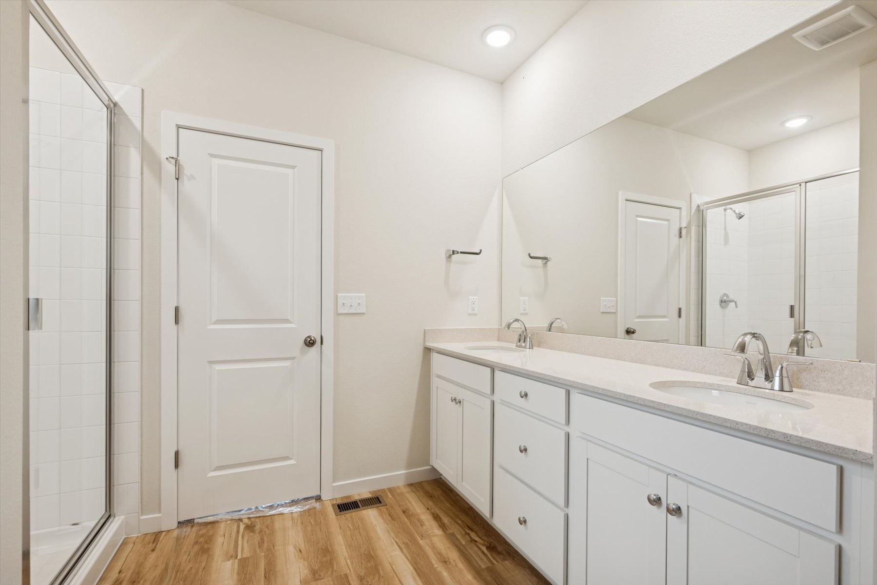 A bathroom with a large mirror.