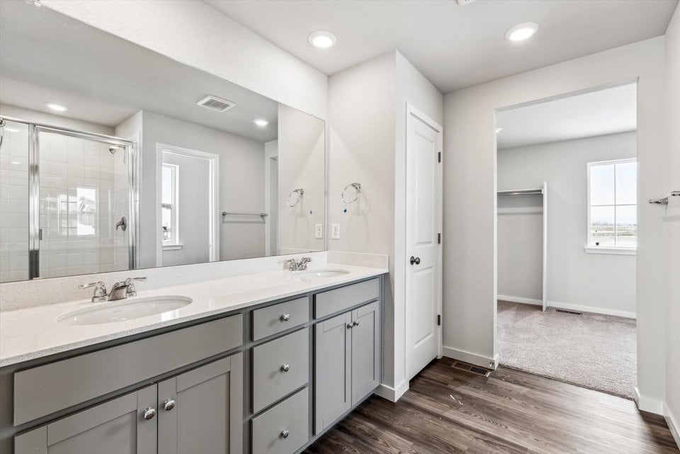 A bathroom with a large mirror.