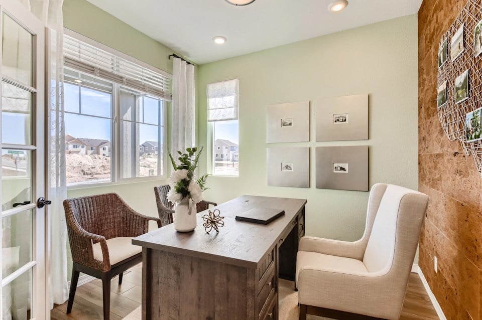 A kitchen with a table and chairs.