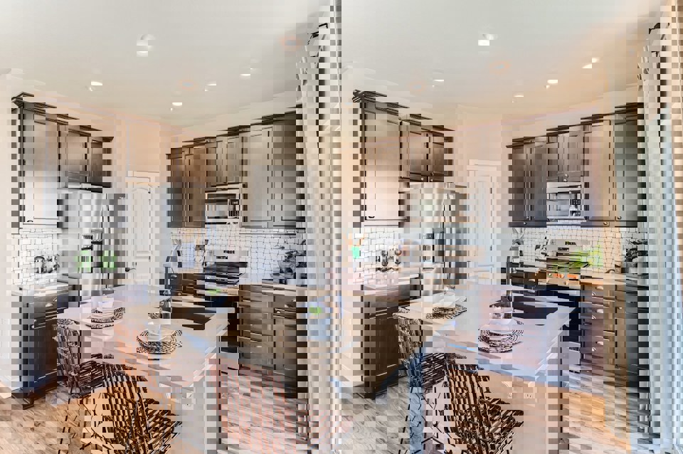 A kitchen with a table and chairs.