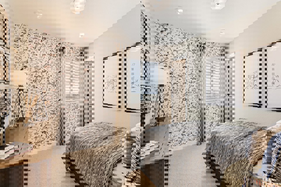 A bedroom with a bed and a lamp.