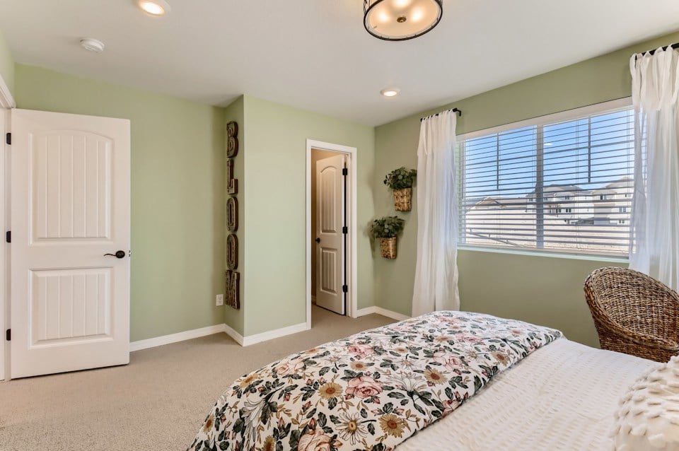 A bedroom with a bed and a window.