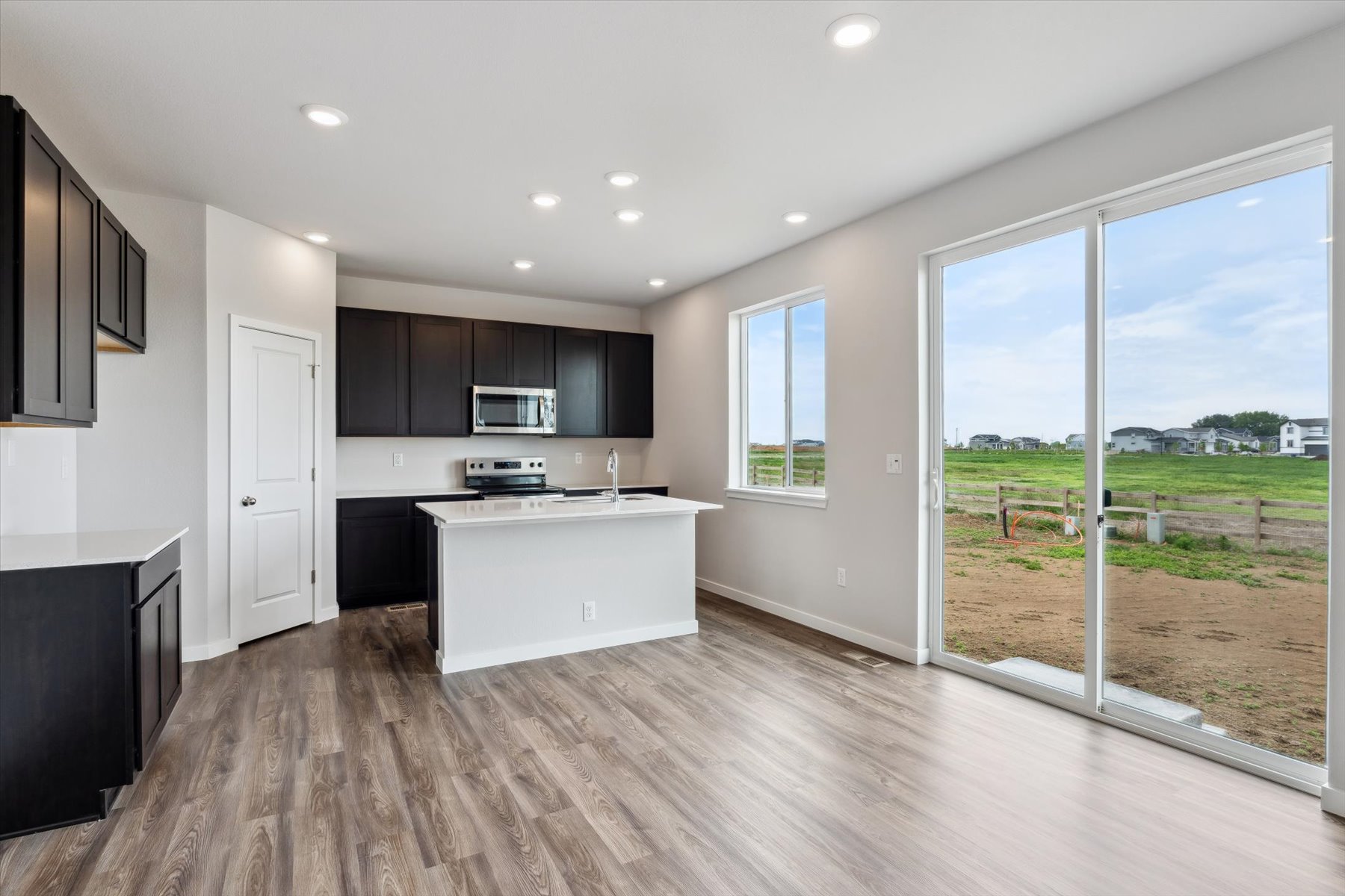 A kitchen with a large window.