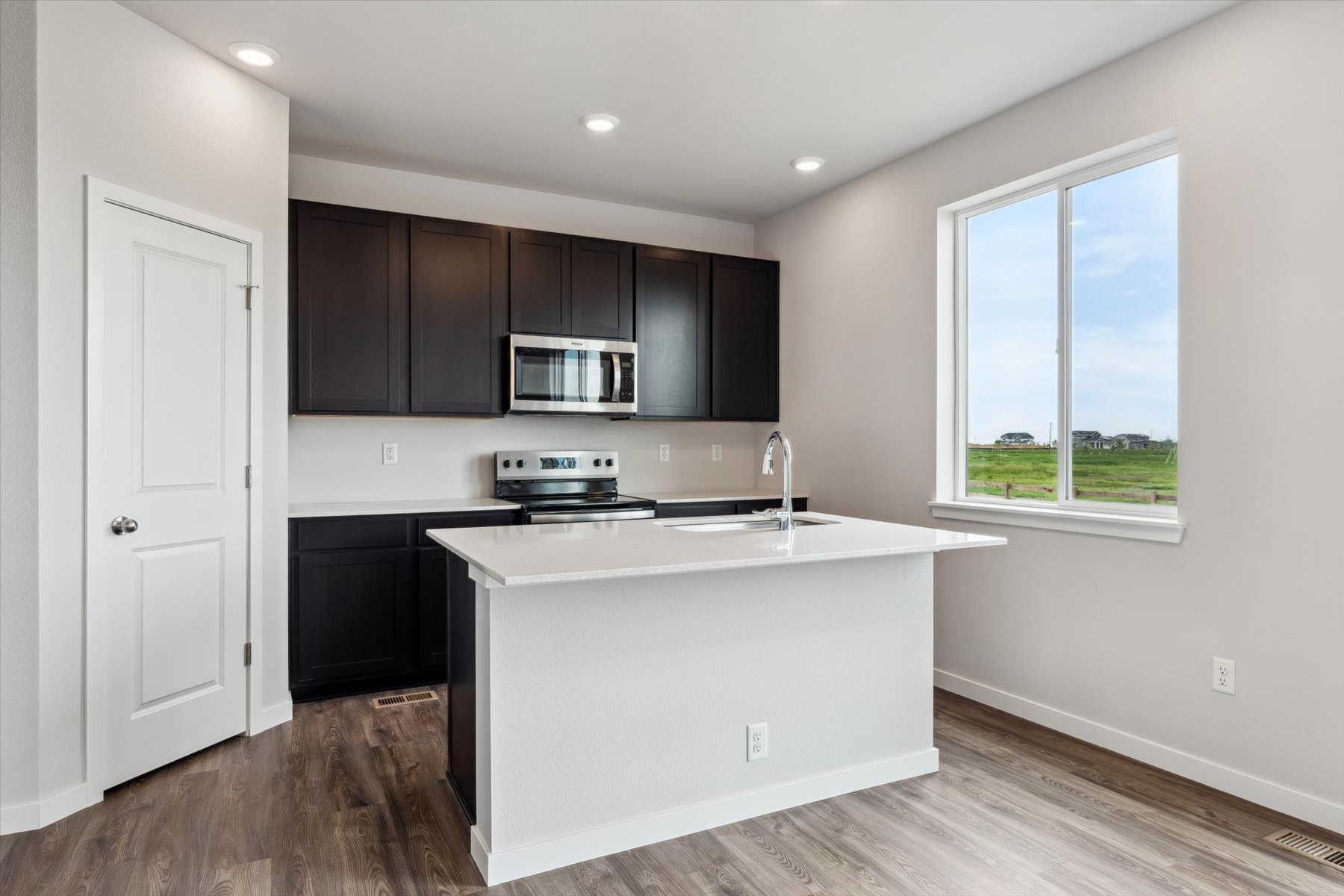 A kitchen with black cabinets.