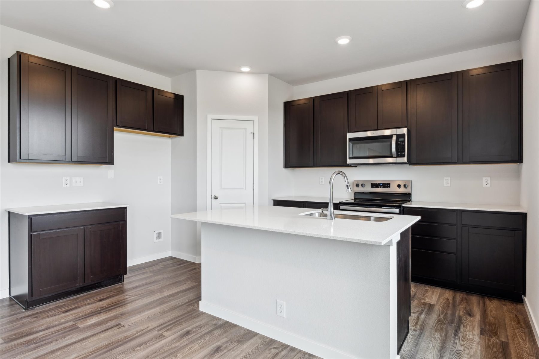 A kitchen with black cabinets.