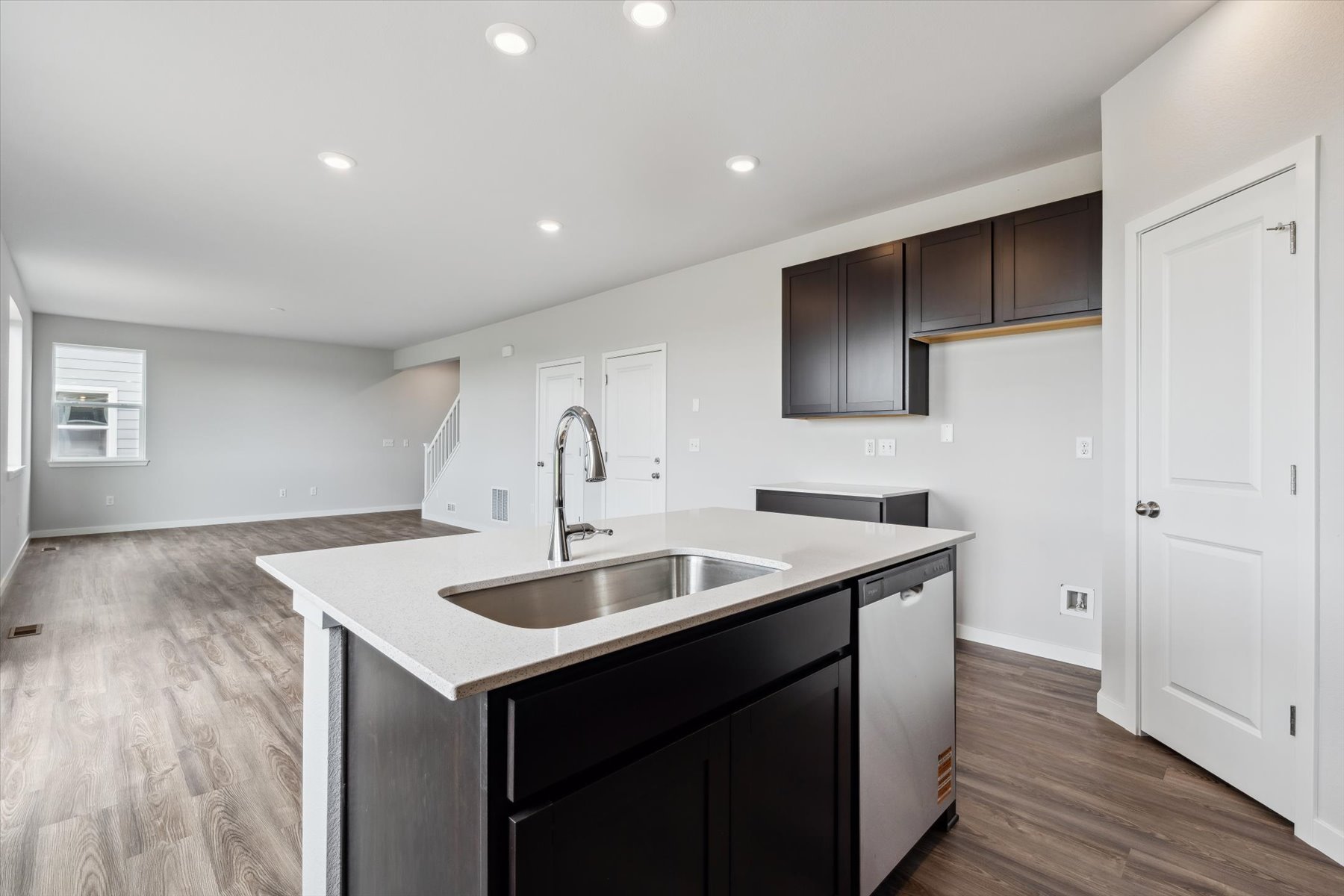 A kitchen with black cabinets.