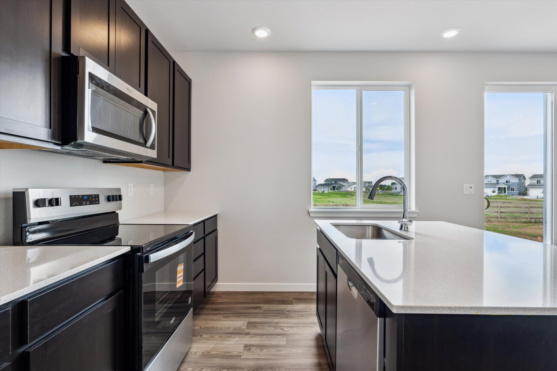 A kitchen with a large window.
