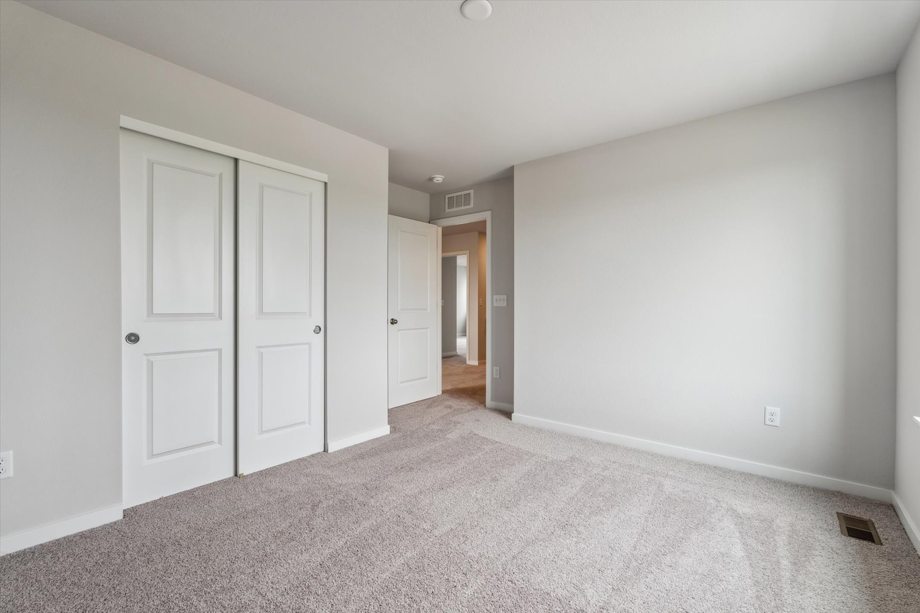 A hallway with white doors.