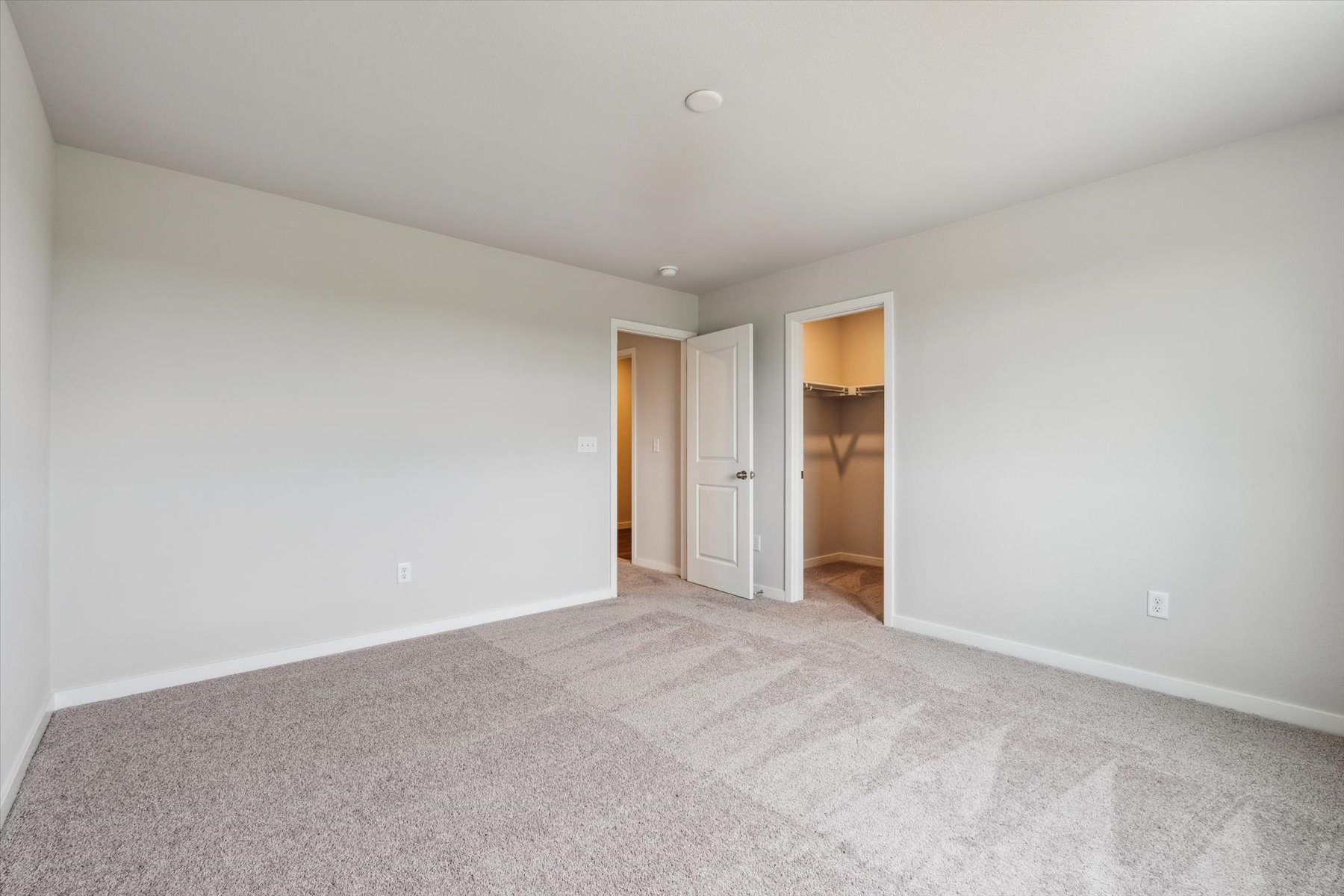 A hallway with white walls.
