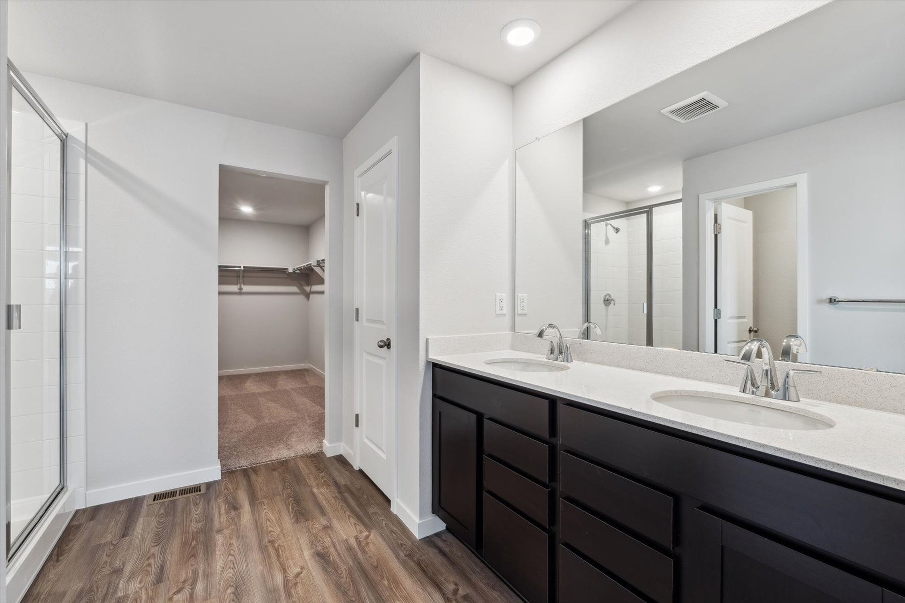 A bathroom with a large mirror.