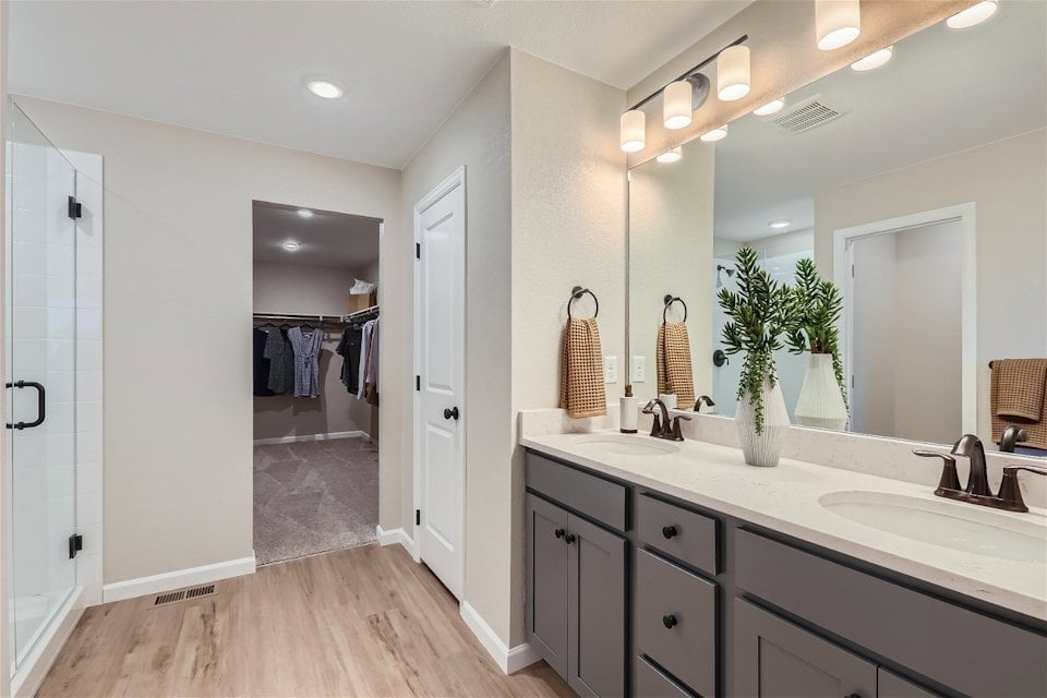 A bathroom with a large mirror.