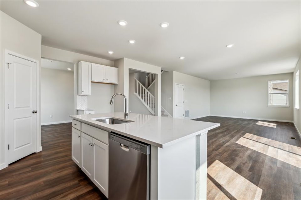 A kitchen with white cabinets.