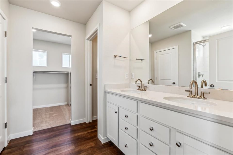 A bathroom with white cabinets.