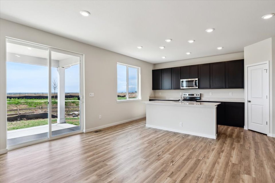 A kitchen with a large glass door.