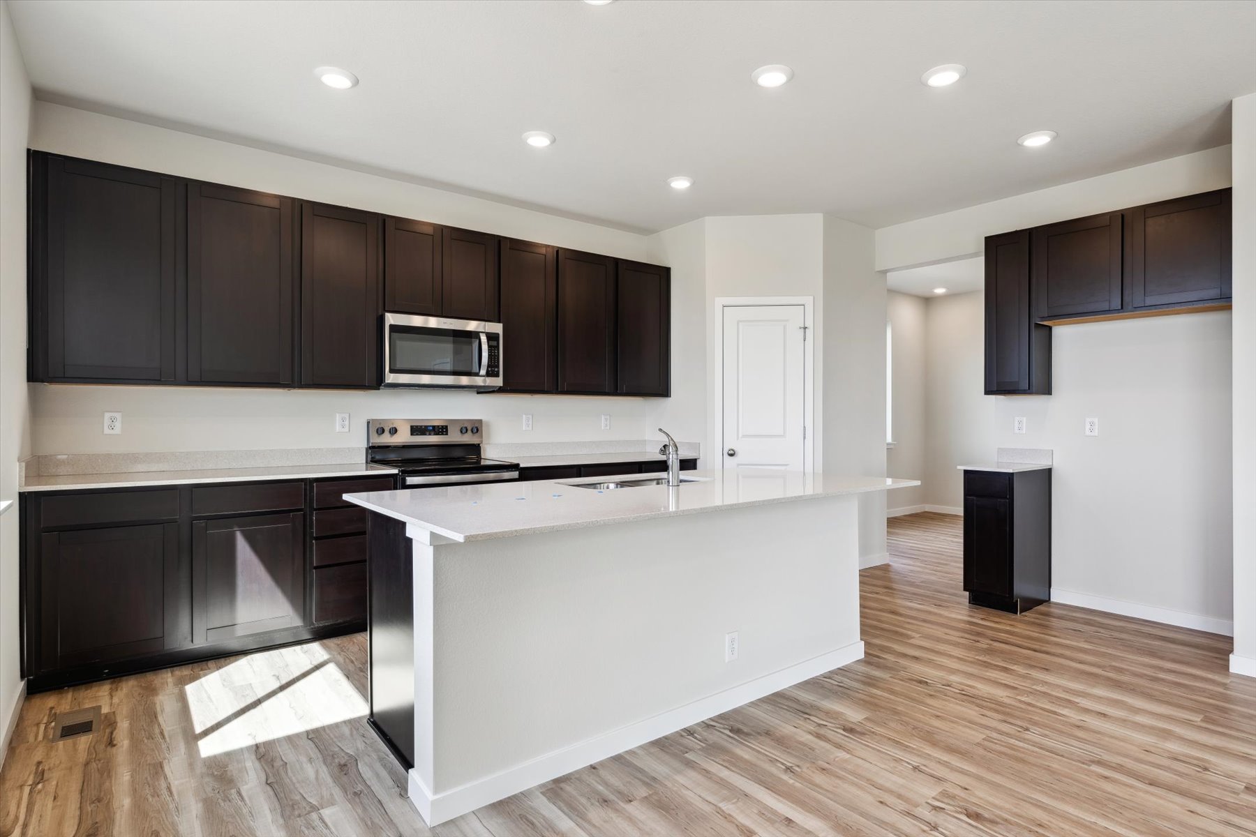 A kitchen with black cabinets.