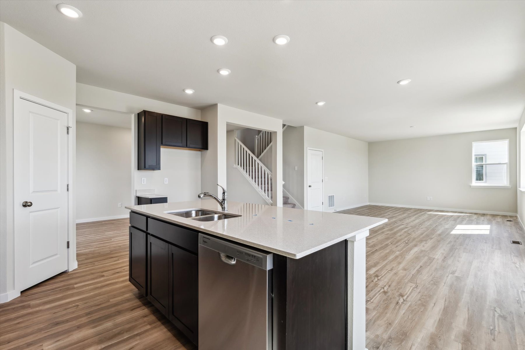 A kitchen with black cabinets.