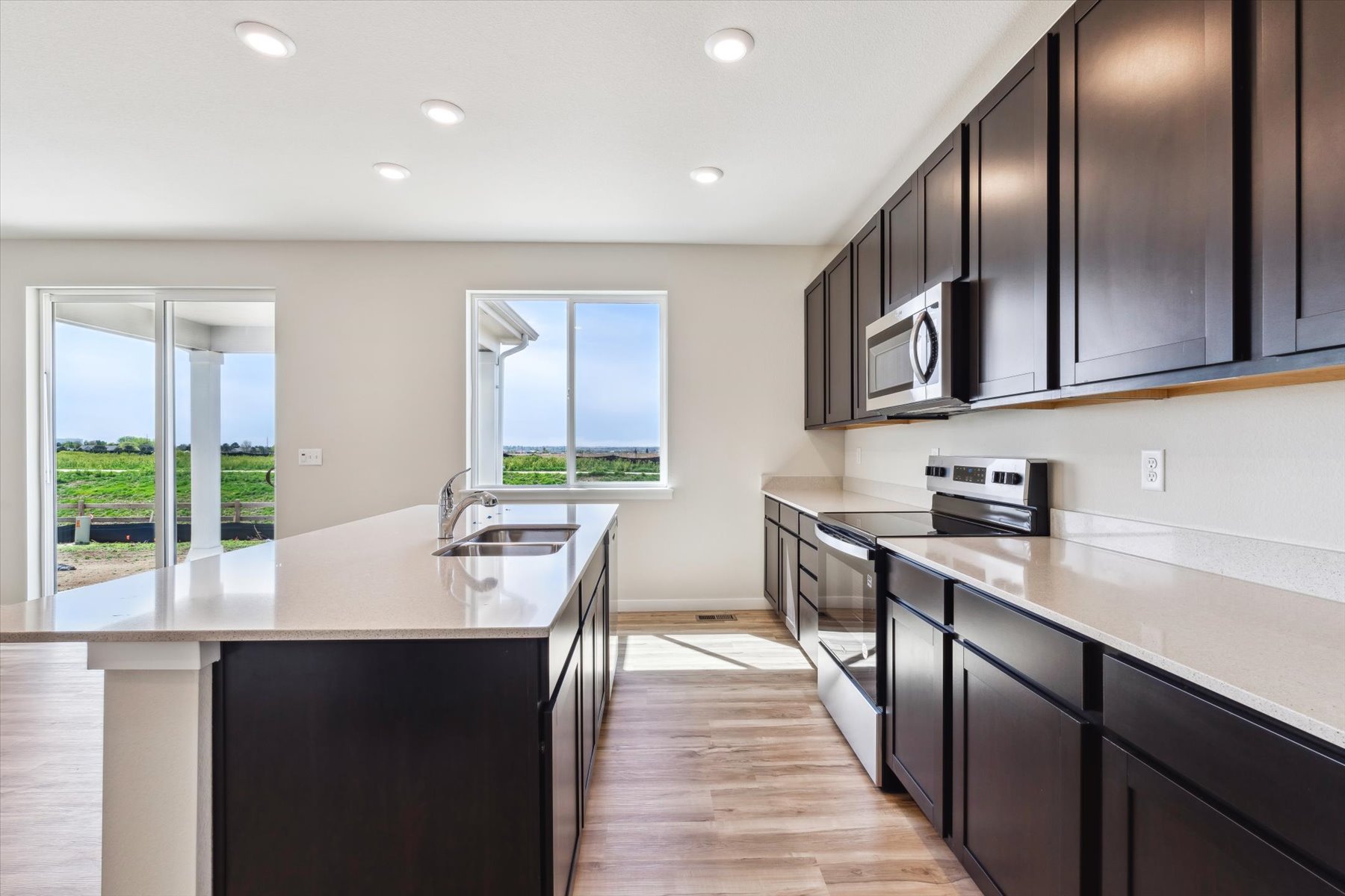 A kitchen with black cabinets.