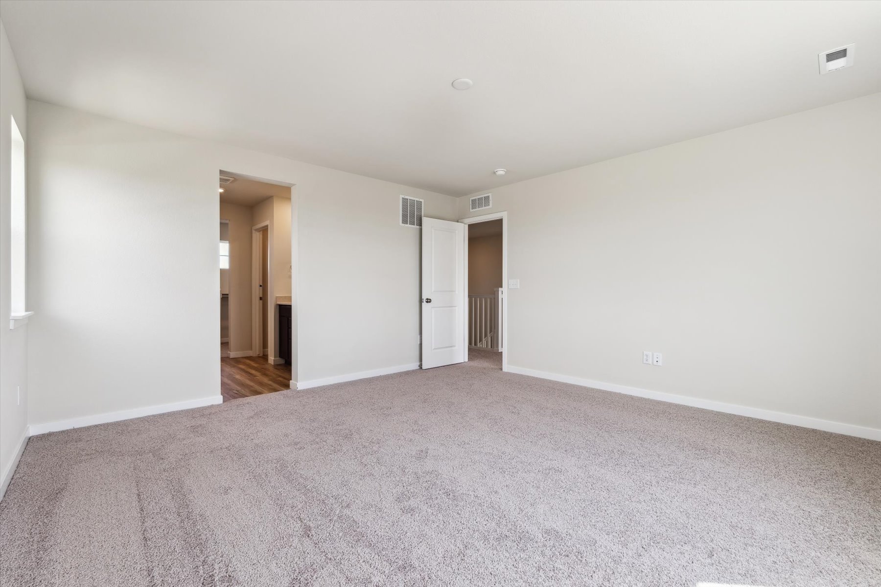 A long hallway with doors.