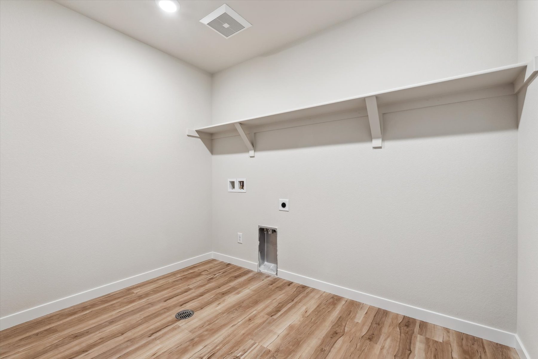 A room with a wood floor and white walls.