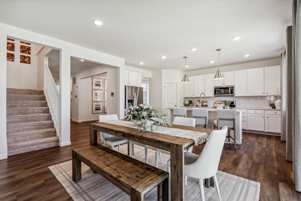 A kitchen with a dining table.
