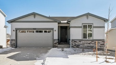 A house with garages and snow.