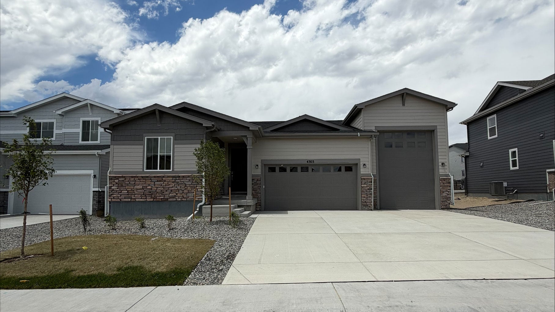 A house with garages and a driveway.