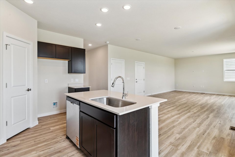 A kitchen with a sink and cabinets.
